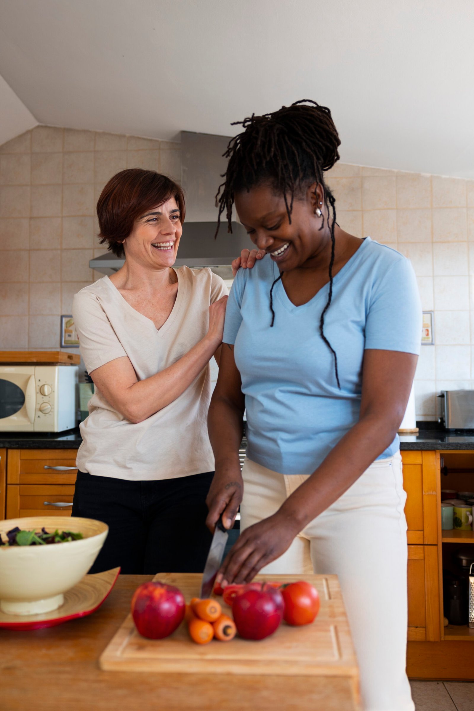 medium shot lesbian couple home with food